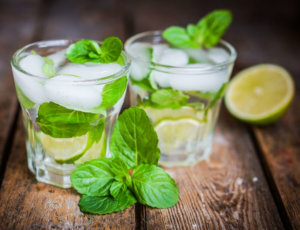 Water with lime,lemon and mint on rustic wooden table